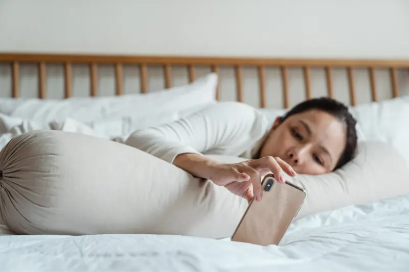 People_dont_do_Their_Physio_Exercises1 A lady laying in her bed, while looking at her phone